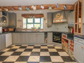 A kitchen with cabinets and a window at Pillars Barnstaple