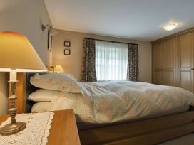 A bedroom with a bed and nightstand at Pillars Barnstaple