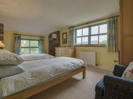 A bedroom with two beds and a dresser at Pillars in Barnstaple