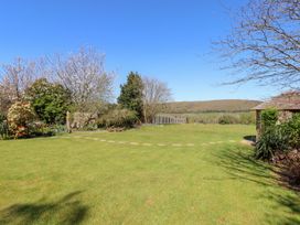A garden with grass and trees at Pillars Barnstaple