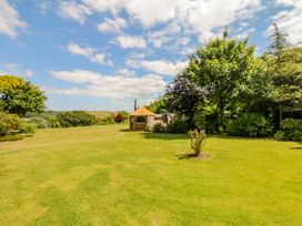 A garden with a shed and trees at Pillars in Barnstaple