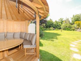 A garden with a circular gazebo and outdoor seating at Pillars in Barnstaple