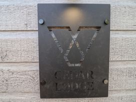 A sign displaying the name Cedar Lodge mounted outdoors at No.11 - Cedar Lodge in Delamere