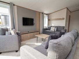 A living room with sofas and a television at No.11 - Cedar Lodge in Delamere