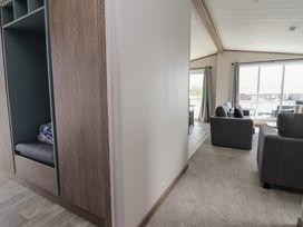 A living room with a couch and window at No.11 - Cedar Lodge in Delamere