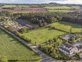 An aerial view of a landscape with buildings and fields at Cedar Lodge 3 Bedrooms with hot tub in Delamere