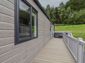 An outdoor area with decking and a hot tub at Cedar Lodge 3 Bedrooms with hot tub, Delamere