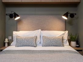 A bedroom with a bed and two bedside lights at Arlington 40 x 14 Three Bed - 2 in Northwich