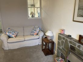 A living room with a sofa and side table at 12 Glyn terrace Borth-Y-Gest