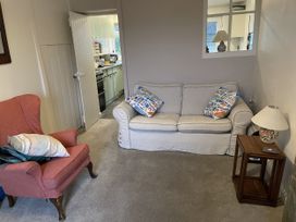 A living room with a sofa and armchair at 12 Glyn terrace in Borth-Y-Gest