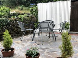 A table and chairs on a patio with potted plants at 12 Glyn terrace Borth-Y-Gest