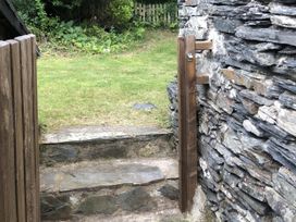 A garden with stone steps and a gate at 12 Glyn terrace Borth-Y-Gest
