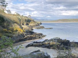 A coastal view with rocks and water at 12 Glyn terrace Borth-Y-Gest
