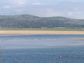 A body of water with land and mountains in the background at 12 Glyn terrace Borth-Y-Gest