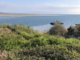 A beach area with people near the water at 12 Glyn terrace in Borth-Y-Gest