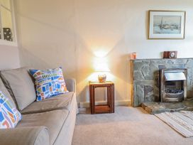 A living room with a sofa and lamp at 12 Glyn Terrace Borth-Y-Gest