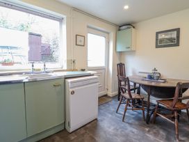 A kitchen with a sink and a table at 12 Glyn Terrace Borth-Y-Gest
