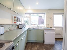A kitchen with a sink and dishwasher at 12 Glyn Terrace in Borth-Y-Gest