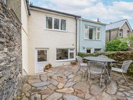 An outdoor patio with a table and chairs at 12 Glyn Terrace Borth-Y-Gest