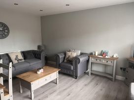 A living room with sofas and a coffee table at 43 Goose Green Road in King's Lynn