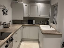 A kitchen with cabinets and appliances at 43 Goose Green Road in King's Lynn
