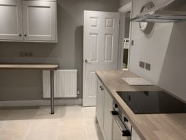 A kitchen with cabinets and a stove at 43 Goose Green Road in King's Lynn