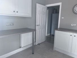 A kitchen with worktops and a door at 43 Goose Green Road in King's Lynn