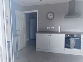 A kitchen with an oven and clock at 43 Goose Green Road in King's Lynn