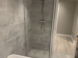 A bathroom with a shower and bathtub at 43 Goose Green Road King's Lynn