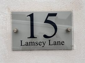 A sign displaying the address 15 Lamsey Lane