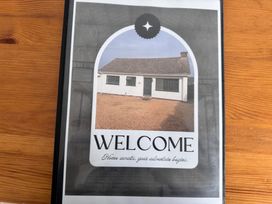 A house exterior with a sign saying welcome at 15 Lamsey Lane in King's Lynn