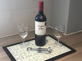 A kitchen with wine bottle and glasses on a tray at 15 Lamsey Lane King's Lynn