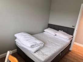 A bedroom with a bed and pillows at 15 Lamsey Lane in King's Lynn