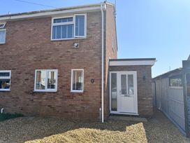 An exterior view of a house with windows and a door at 22 Sandringham Drive in King's Lynn