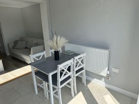A dining room with a table and chairs at 22 Sandringham Drive in King's Lynn