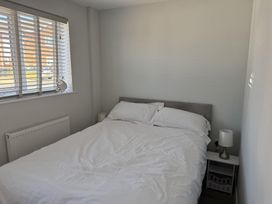 A bedroom with a bed and bedside table at 22 Sandringham Drive in King's Lynn