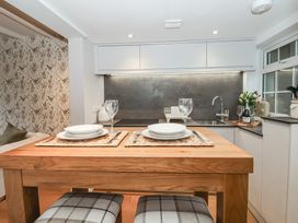 A kitchen with a wooden table set for two at No.4 Main Street Hull