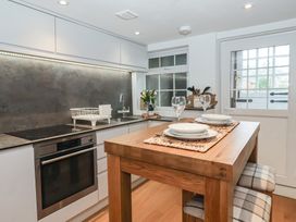 A kitchen with a table and chairs at No.4 Main Street in Hull