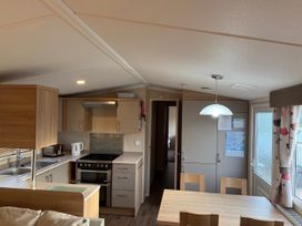 A kitchen with cabinets and appliances at 55 Cambrian Park