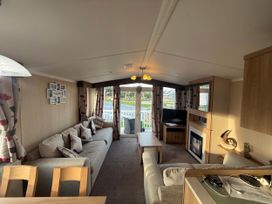 A living room with a sofa and television at 55 Cambrian Park