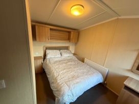 A bedroom with a bed and bedside table at 55 Cambrian Park