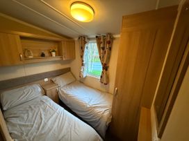 A bedroom with two beds and a window at 55 Cambrian Park