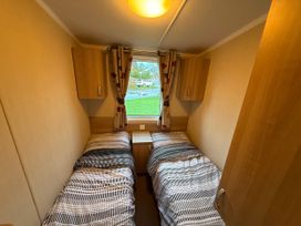 A bedroom with two beds and a window at 55 Cambrian Park