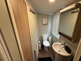 A bathroom with a toilet and sink at Hafan Y Mor Haven Pwllheli
