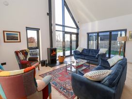 A living room with a sofa and fireplace at 1 Dairy Fields in Longframlington