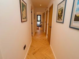 A hallway with doors and pictures at 1 Dairy Fields Longframlington
