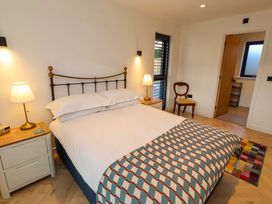 A bedroom with a bed and lamp at 1 Dairy Fields Longframlington