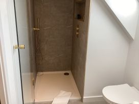 A bathroom with a shower and a toilet at The Barn in Longframlington