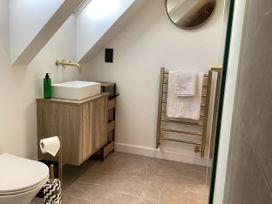 A bathroom with a sink and towel rack at The Barn in Longframlington