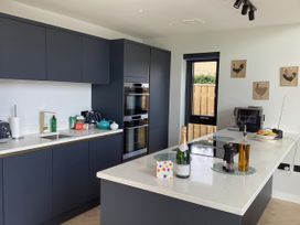 A kitchen with cabinets, countertop, and appliances at The Barn in Longframlington